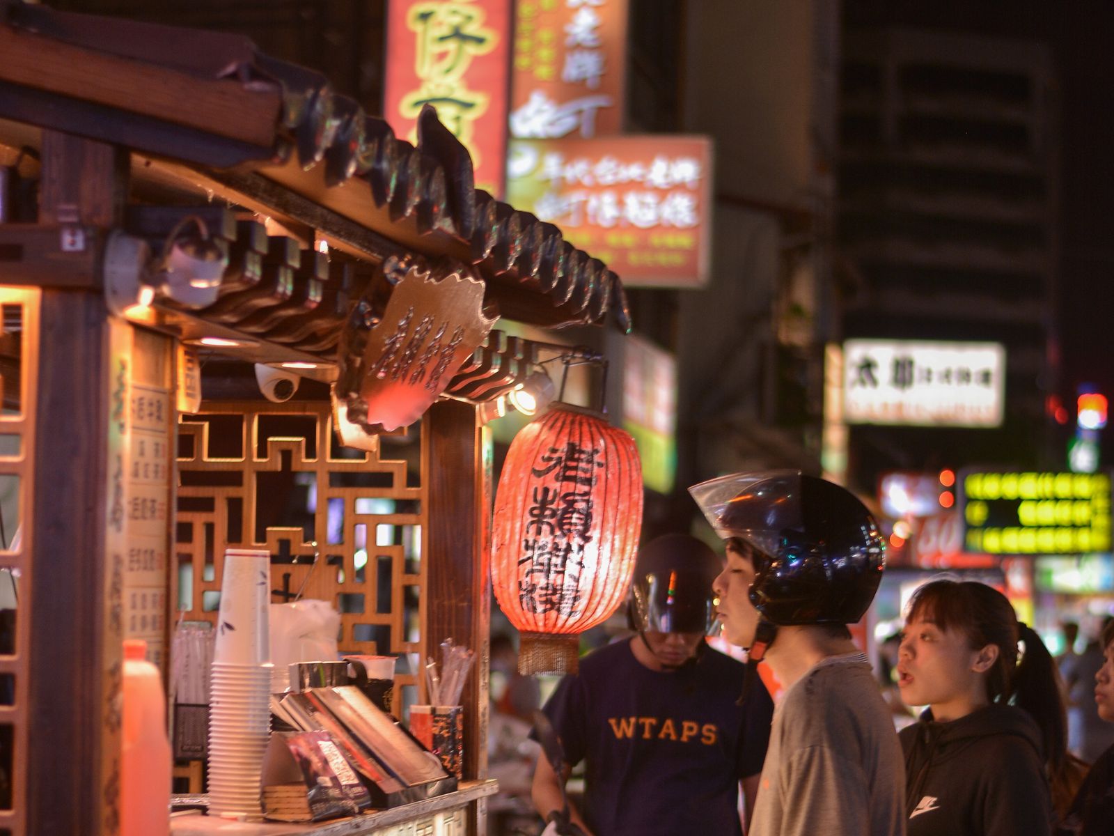 Customers at a lantern-lit food cart in a Taiwan night market